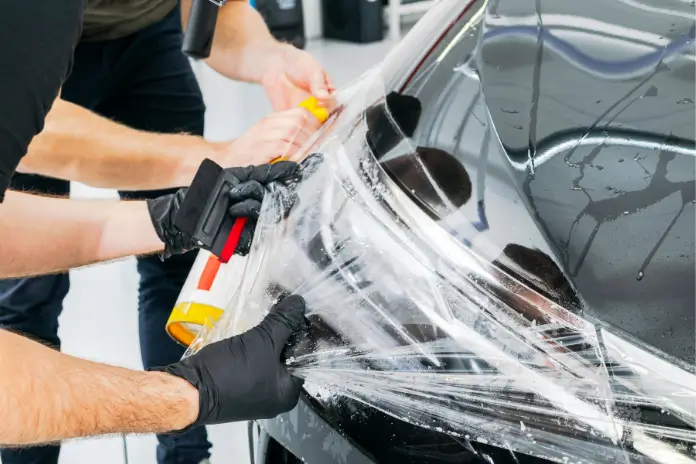 Ilustrasi pemasangan Paint Protection Film (PPF). (Foto: Canva Pro/Getty Images/bigtunaonline)